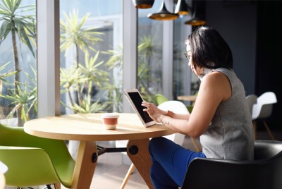 Woman In Eco-friendly Office With Reusable Cup