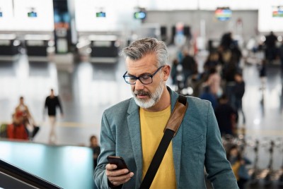 Male-employee-checking-phone-while-on-business-travel1.jpg