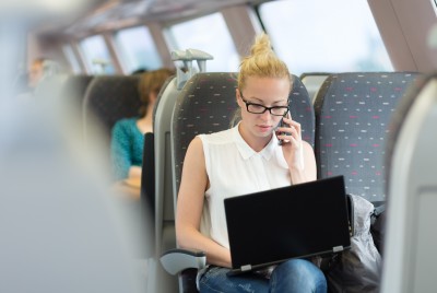 business_woman_working_on_a_train.jpg